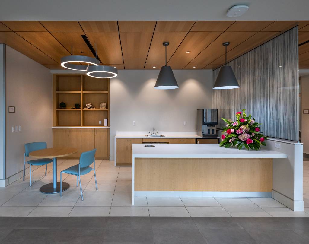 Modern office breakroom with island and flowers