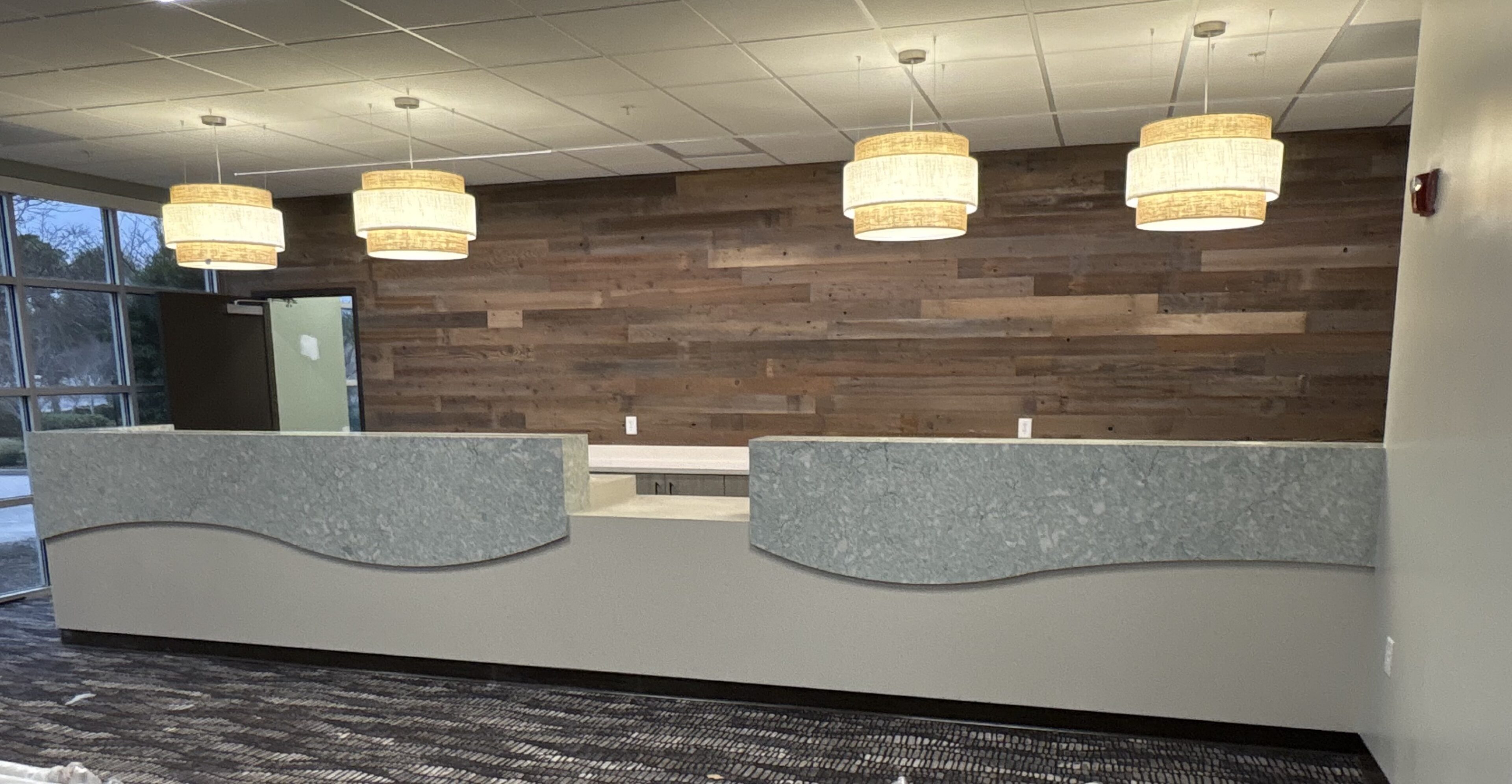 Modern reception desk with wood accent wall
