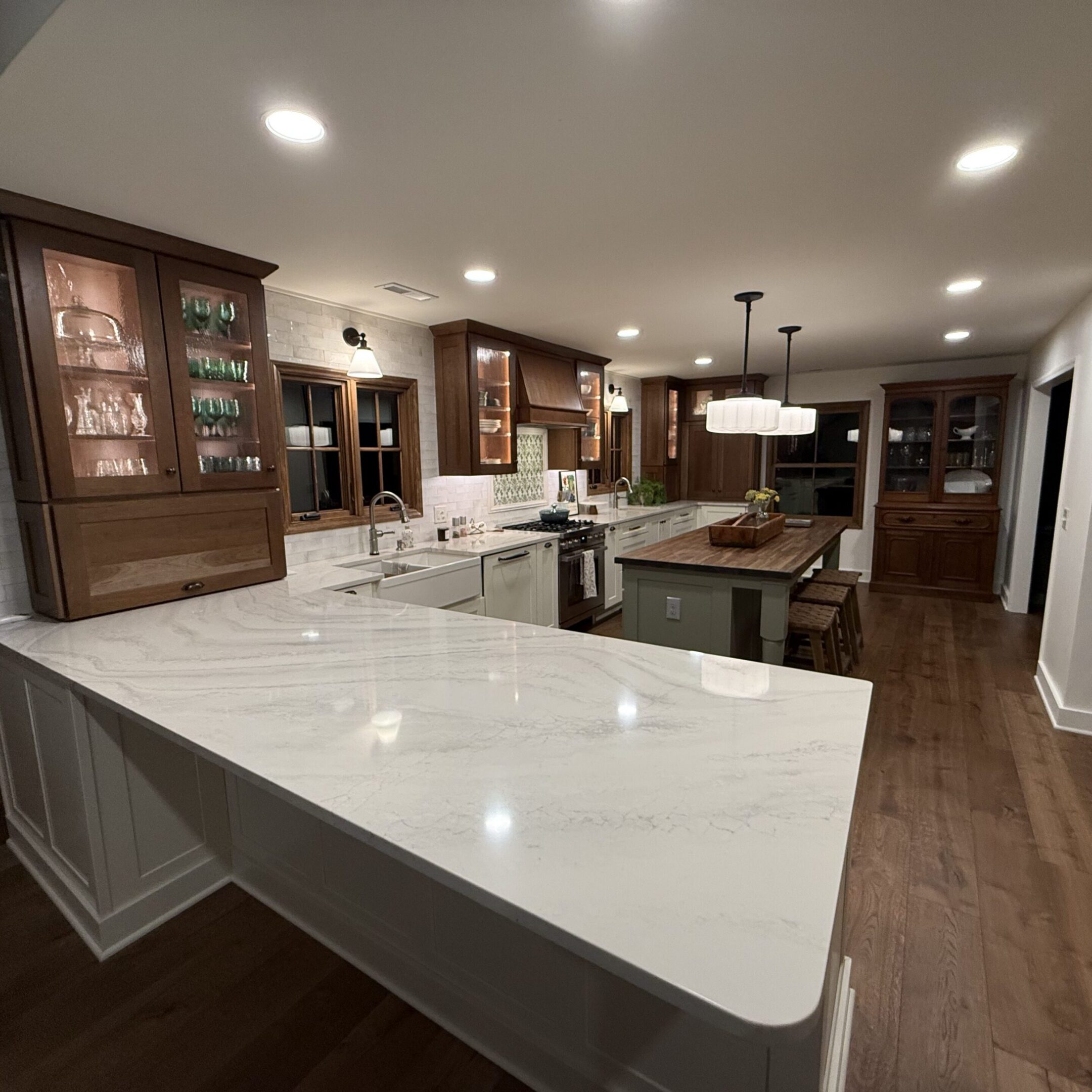 Modern kitchen with marble countertop and wood cabinets